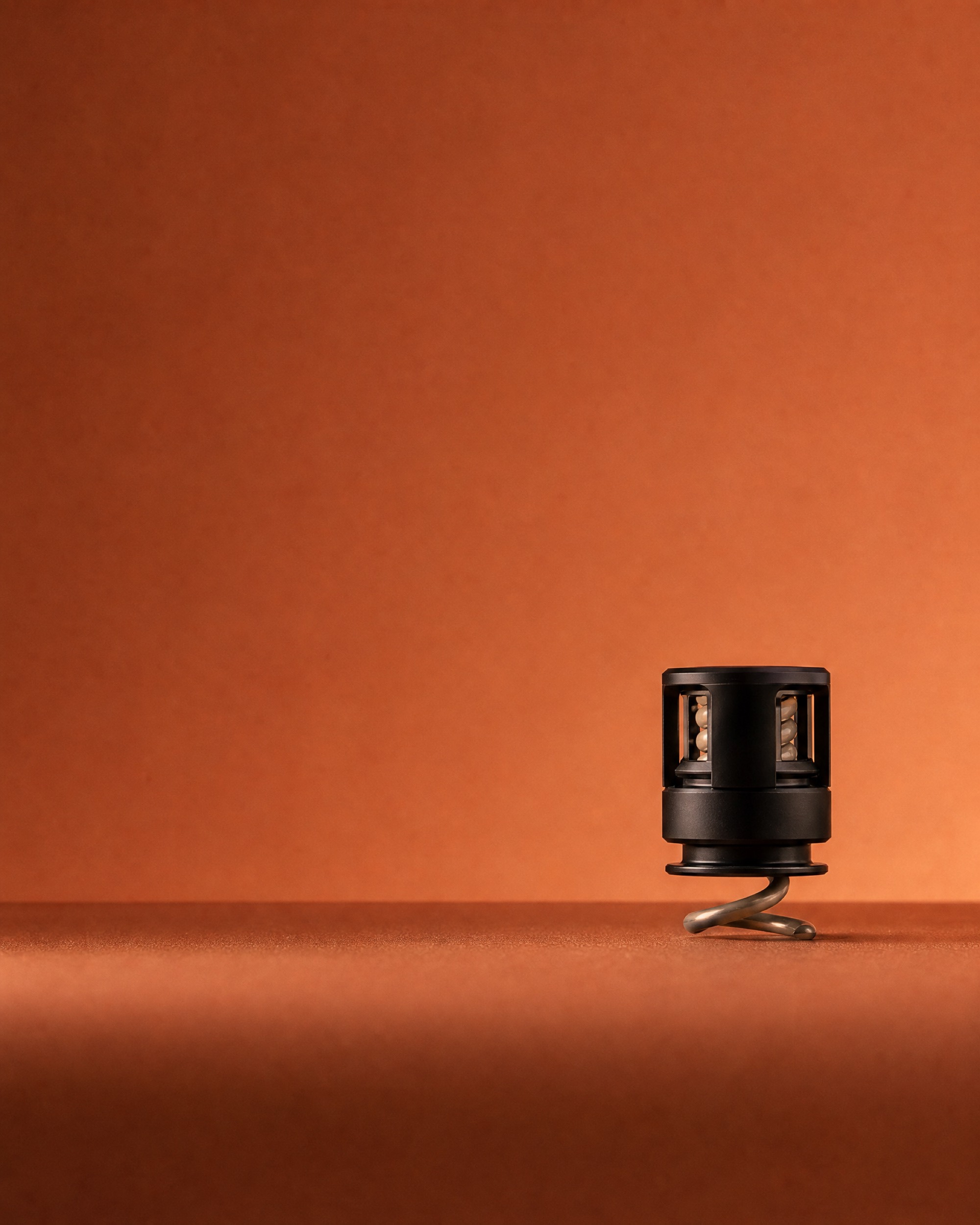 The Syn-R1 electrode standing upright, its compliant spring tip below a black housing